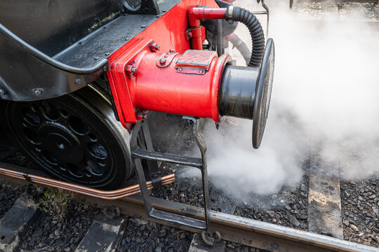 Shallow focus of copper steam pipes seen exhausting hot, compressed steam from the boiler for an English locomotive.