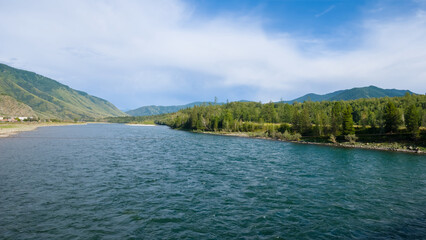 wide river flow among green mountain