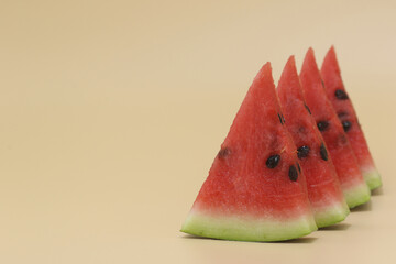 slices of fresh watermelon isolated on yellow background	
