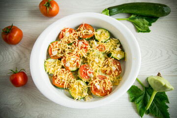 raw zucchini and tomatoes sliced with cheese, prepared for baking