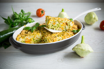 vegetable casserole of patissons, zucchini, carrots in a ceramic form .