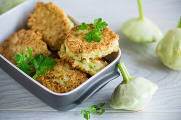 vegetable fried squash and zucchini cutlets in a ceramic form