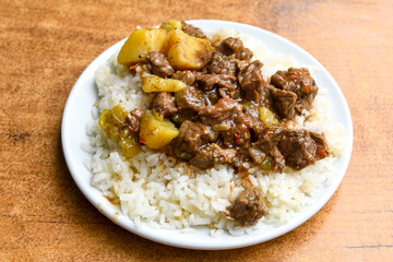 Beef steak grill with rice pilaf, fried potatoes, grilled pepper and tomatoes.Mix Platter with Beef rips, Cutlets, Potatoes and Sauces.