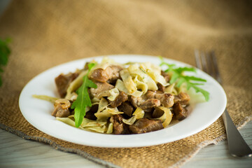 Homemade boiled noodles with meat and eggplant in a plate