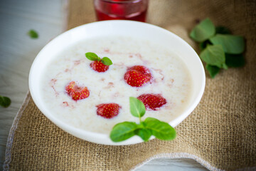 sweet milk oatmeal with strawberries in a plate