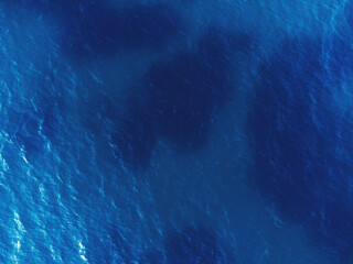 Fototapeta na wymiar Aerial top view of blue colored sea texture with drone