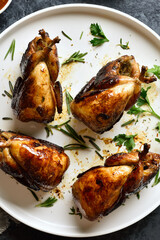 Roasted quails on plate