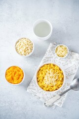 Millet porridge with pumpkin puree and cheese in a bowl