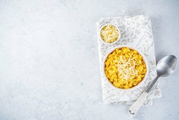 Millet porridge with pumpkin puree and cheese in a bowl