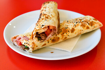 Lavash doner kebab ( zurna doner durum )  or shawarma sliced in plate isolated. 