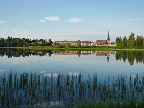 Mora F&ouml;rsamling Church in Sweden reflecting in the Water on a bright morning.