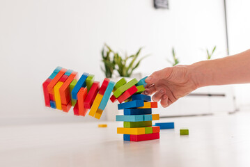 Board game Tower made of wooden blocks. A tower of unevenly shifted wooden beams. A lesson for agility, logic and coordination. Home entertainment. Balance.