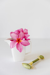 Plumberia rumba in a coffe cup, eucalyptus branch in a vase and cup of coffee on a white table...