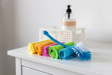 Multi-colored fiber cloths for dusting and a plastic brush