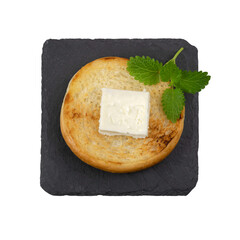 Slices of hot toast with butter on a black slate plate.Top view.Isolated on a white background