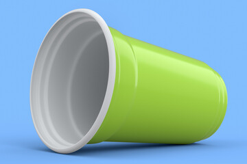 Plastic disposable party cup for juice, fresh, beer on blue background.