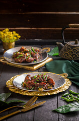 Tangra Chili Chicken served in a dish isolated on dark background side view food