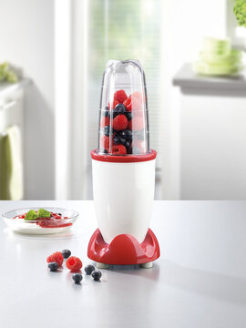 Mini hand mixer with fruits on white kitchen table Stock Photo | Adobe Stock