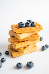 sweet dish Belgian waffles with blueberries on a white background