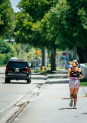 Fototapeta na wymiar woman running in the street miami summer hot 