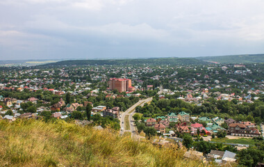 Panoramic top view of the city of Pyatigorsk in Russia on a cloudy summer day and a copy space on the horizon