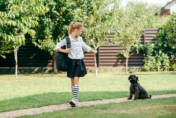 back to school. person walking dog