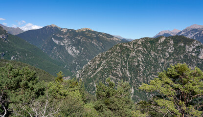 Fototapeta na wymiar forested canyon and gorge in a mountain range, clear blue summer sky