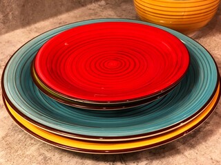 Fototapeta na wymiar Colorful plates stacked on a countertop