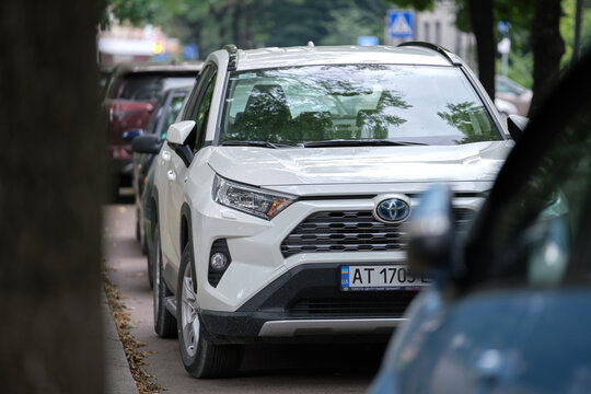 Cars parked in line on city street side. Urban traffic concept. Kyiv, Ukraine - July 5, 2021.