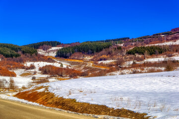 Mountain landscape in Bosnia and Herzegovina covered with snow during sunny winter day.