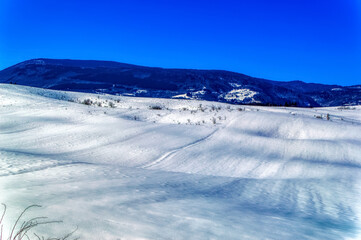 Fototapeta na wymiar Mountain landscape in Bosnia and Herzegovina covered with snow during sunny winter day.
