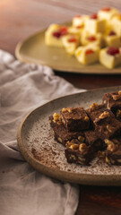 Chocolate fudge on a rustic ceramic , wood surface and linen