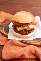 Choripan sandwich with chimichurri, sausage, tomato, mayo and cheese