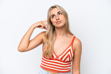 Young caucasian woman isolated on white background making the gesture of madness putting finger on...