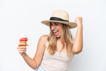 Young caucasian woman with a cornet ice cream isolated on white background celebrating a victory