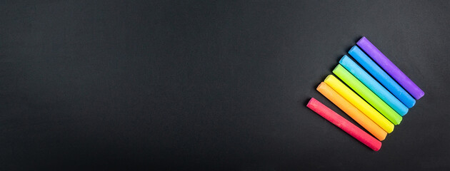 Multicoloured chalk on blackboard background © alexbush