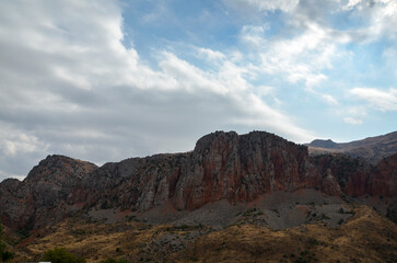 Armenian landscape with brick-red cliffs rock formations near Noravank monastery complex