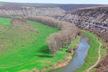 Aerial view over spring landscape . Riverside valley view from above