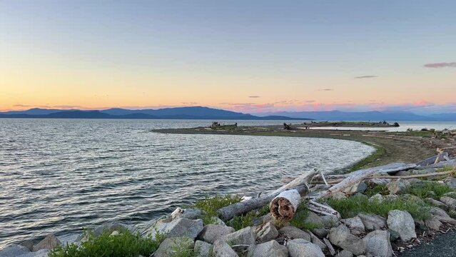 sunset on Ocean Horizon mountains are far visible many clouds and bright colors slow motion video suitable for music relaxation background For text silence peace Parksville beach Surfside RV resort