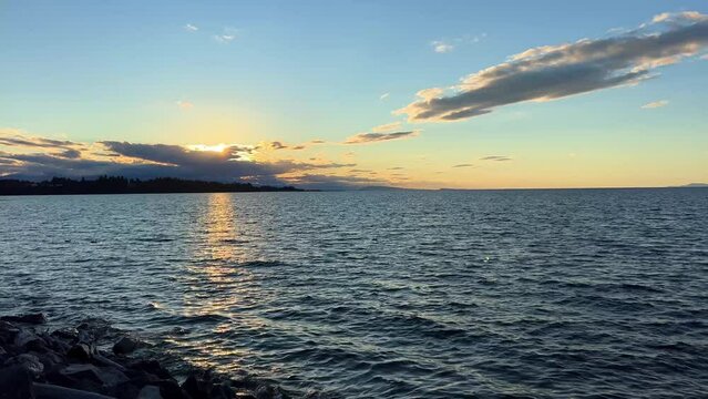 sunset on Ocean Horizon mountains are far visible many clouds and bright colors slow motion video suitable for music relaxation background For text silence peace Parksville beach Surfside RV resort
