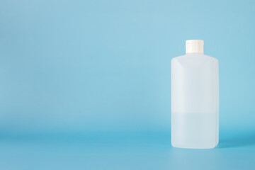 white plastic bottle for hand sanitizer on blue background.