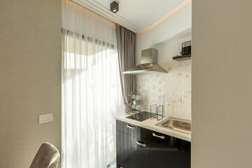 Small kitchen interior in hotel apartment