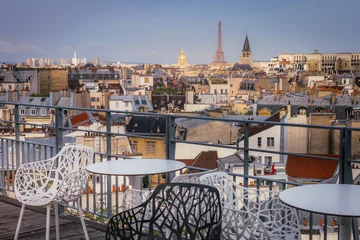 Foto auf Glas Eiffel tower and parisian roofs at sunrise Paris, France © Aide
