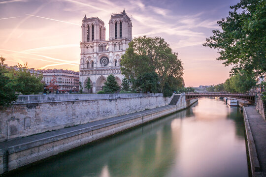 Notre Dame Cathedral of Paris and Seine river at dramatic dawn, France