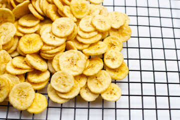 Banana slice chips on white background.