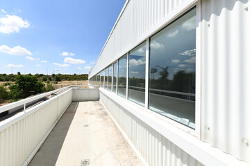 Viewpoint terrace of an industrial warehouse with a large window along the entire length of the facade