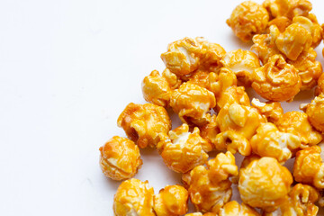 Honey caramel popcorn on white background.