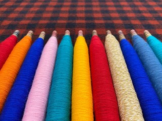 Colorful threads. Yarn. Bobbins with yarn. Fabric. Sewing threads. Skein of thread. Texture of colorful thread in spoolls.
