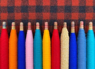 Colorful threads. Yarn. Bobbins with yarn. Fabric. Sewing threads. Skein of thread. Texture of colorful thread in spoolls.