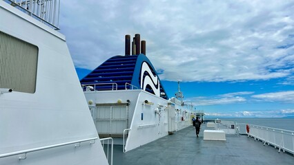 Naklejka premium The upper deck of the ferry departing from Canada to Vancouver Island is a clean white deck with a blue flag white stripes on a blue background This is the flag of the ferry everywhere sea-ocean.